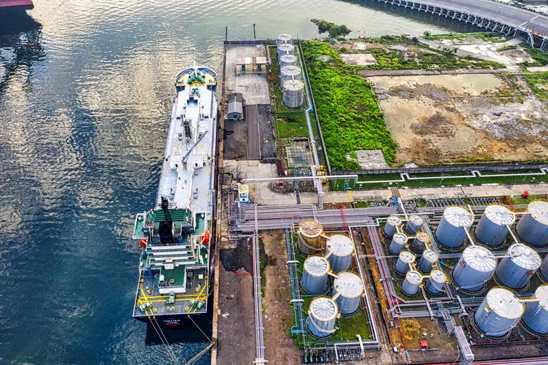 Tanker at a liquid fuel terminal with storage tanks and pipelines